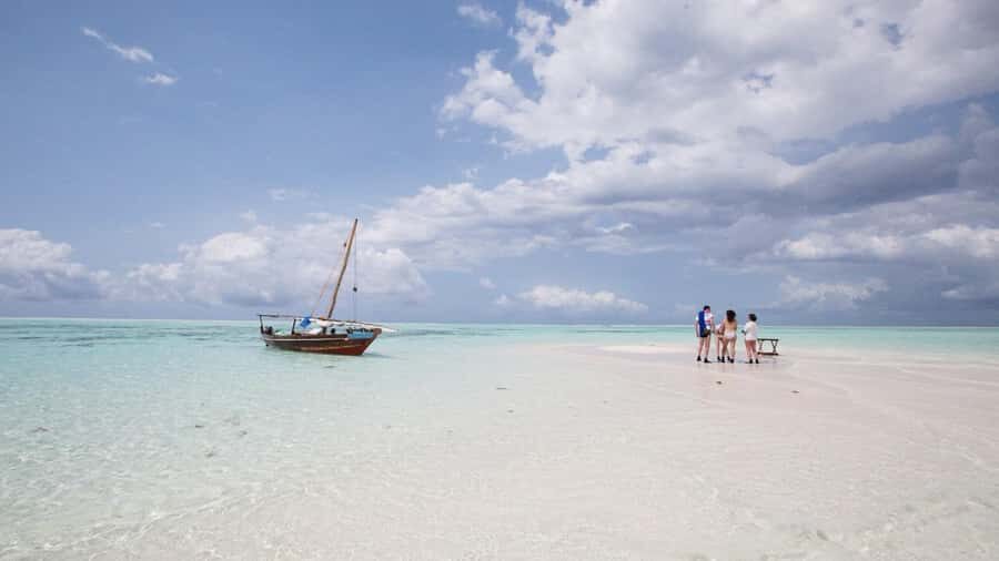 From Zanzibar: Prison Island With Nakupenda Tour - Getting There: Pickup, Van Transfer, and Tide-Driven Boat Timing